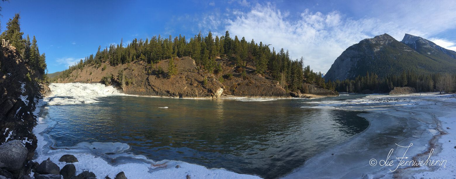 Partially-frozen Bow Falls & the Bow River in Banff National Park during winter.