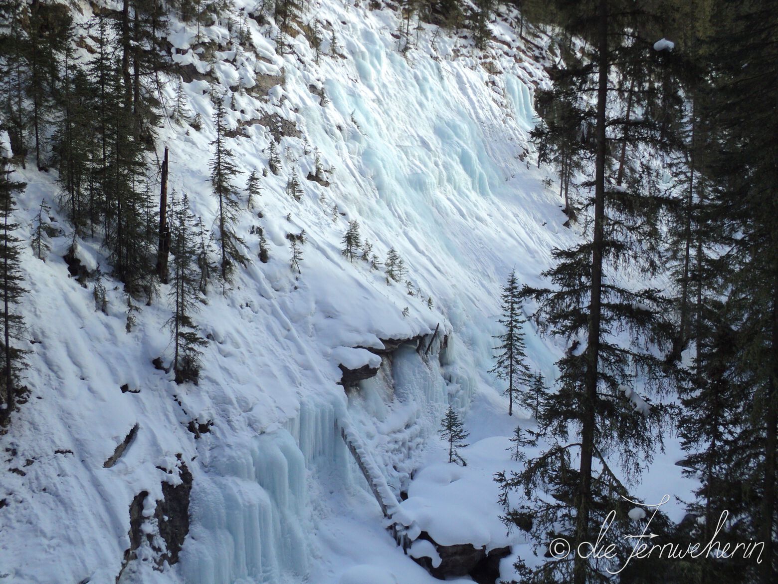 The snow & ice-covered walls of Banff National Park's Johnston Canyon in the winter.