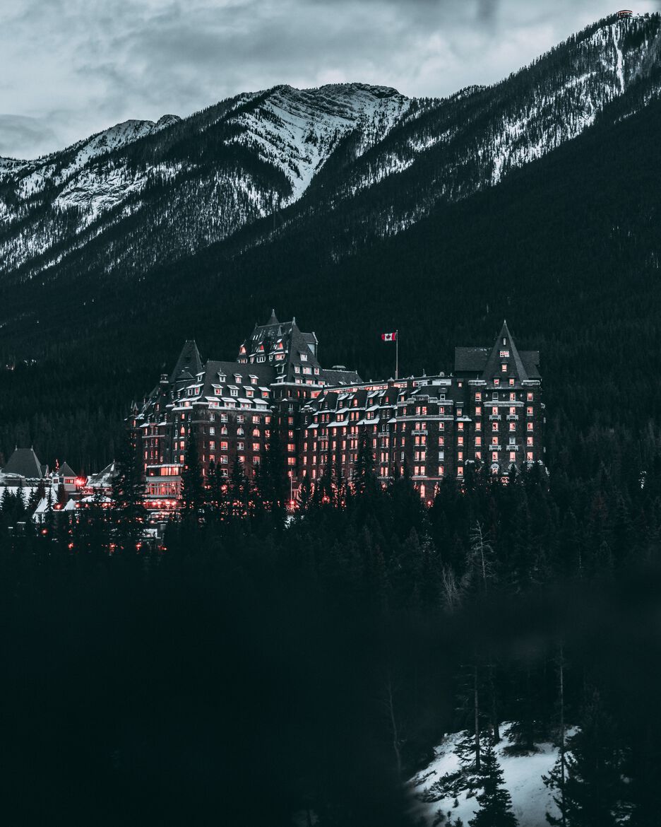 An evening view from Surprise Corner of Bow Falls and the Banff Springs Hotel with all its windows lit up.