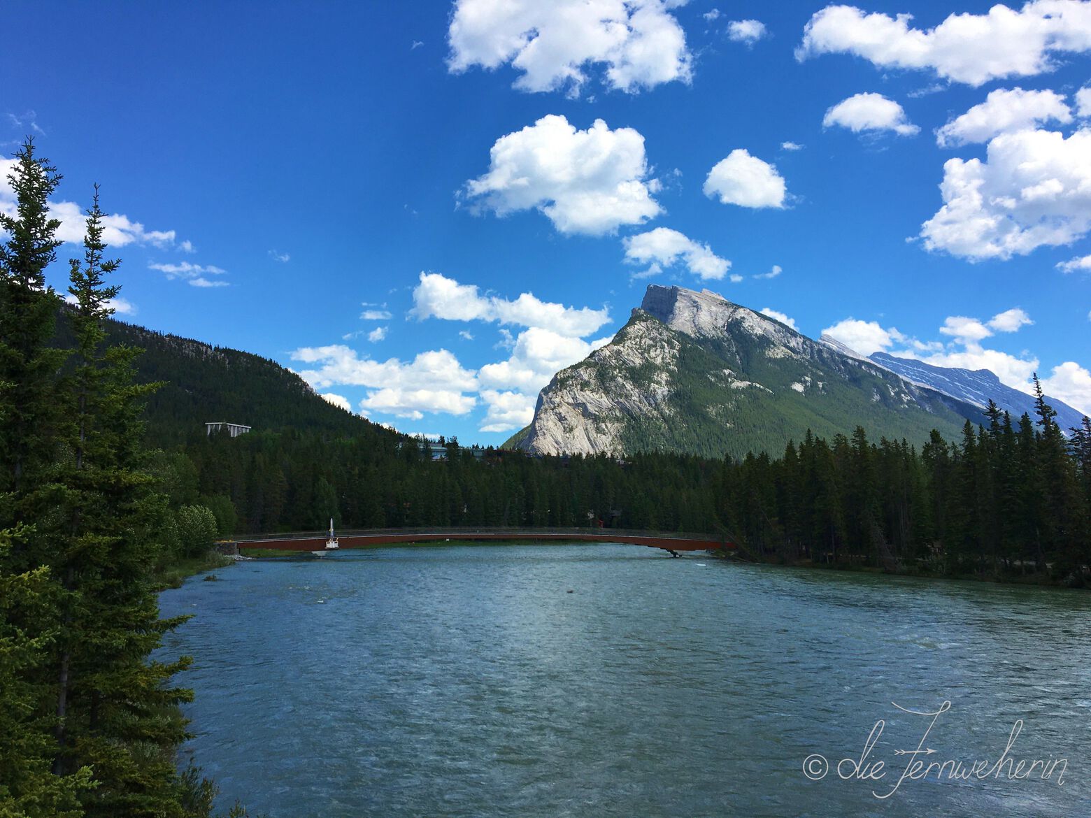 The Bow River Pedestrian Bridge in the town of Banff (with Rundle Mountain in the background).