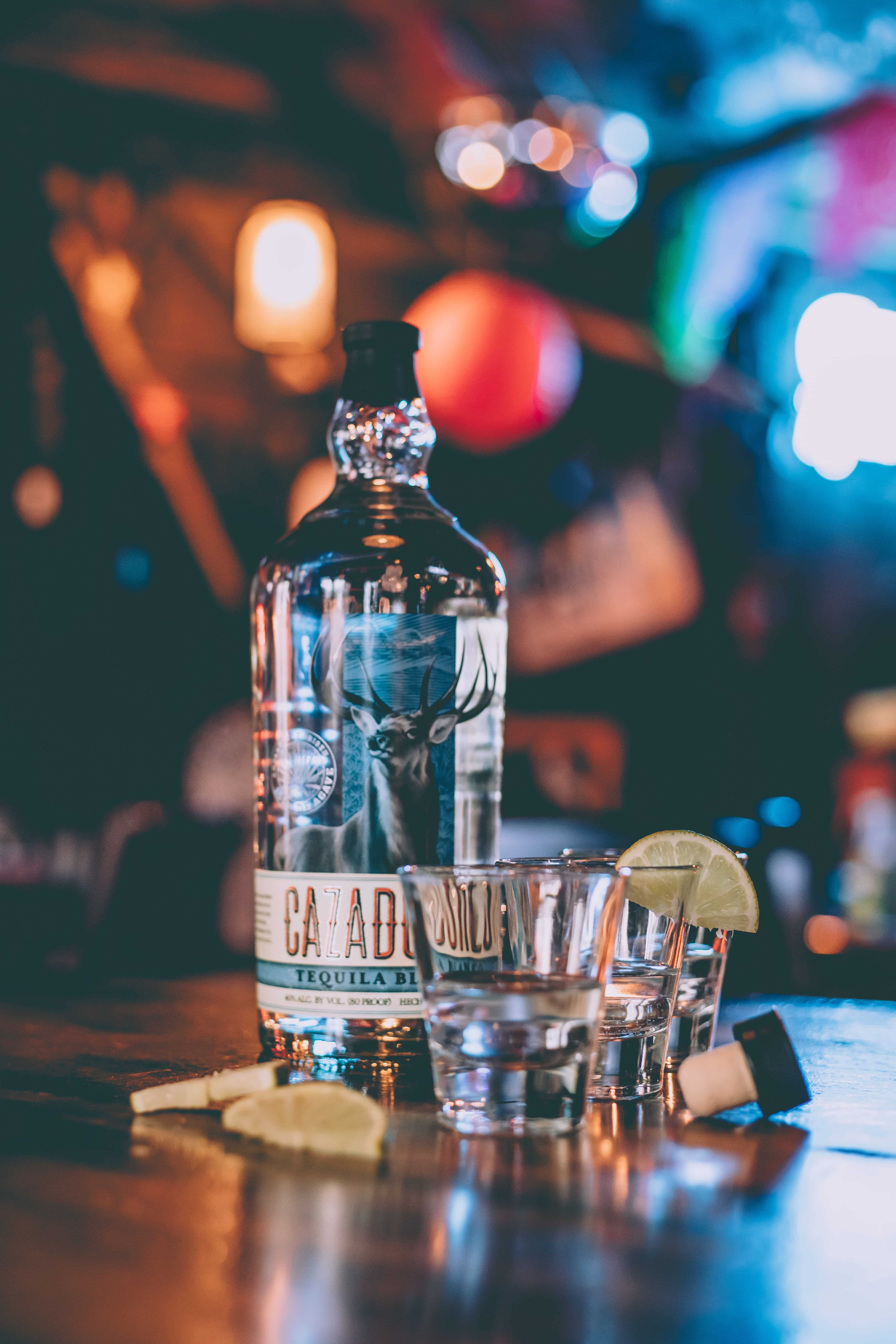 A bottle of tequila & shot glasses at Magpie & Stump, a restaurant in the town of Banff.