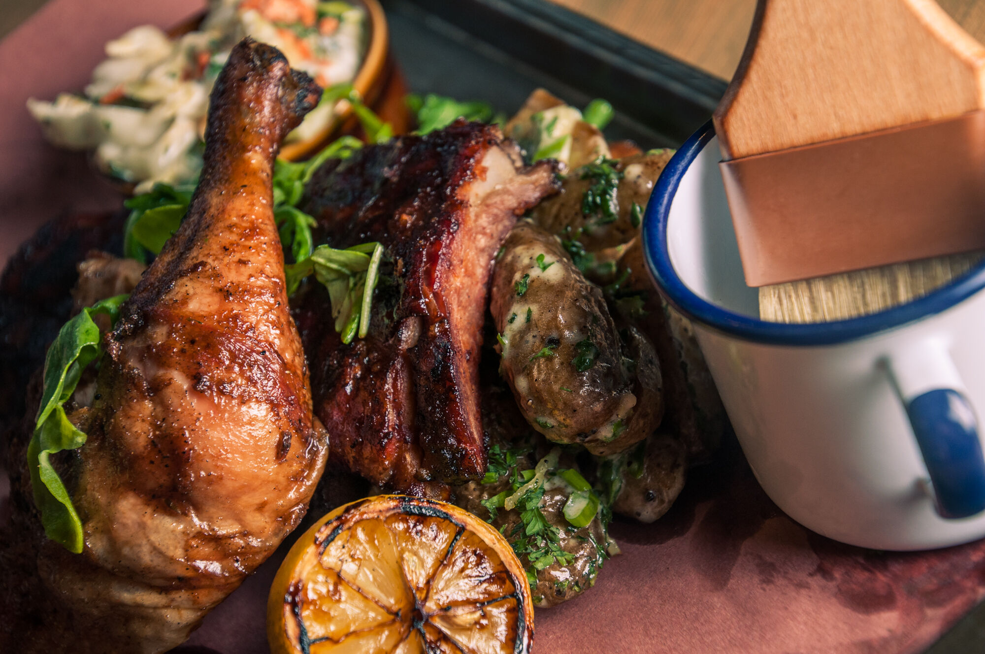 A leg of rotisserie chicken and a half rack of ribs on a bed of greens at Park Distillery, Restaurant & Bar in the town of Banff.