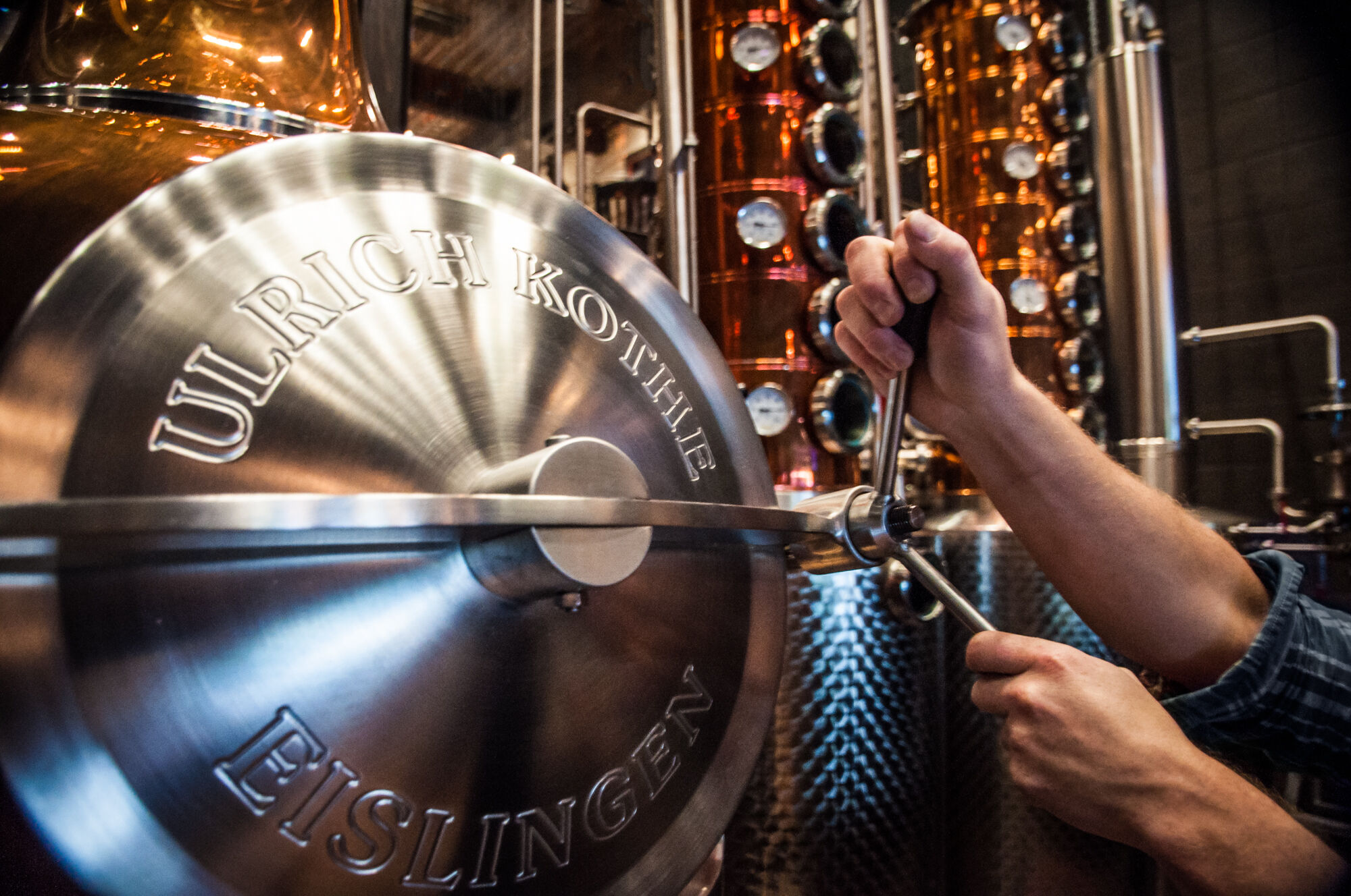 A man turns a crank on a vodka still at Park Distillery, Restaurant & Bar in the town of Banff.