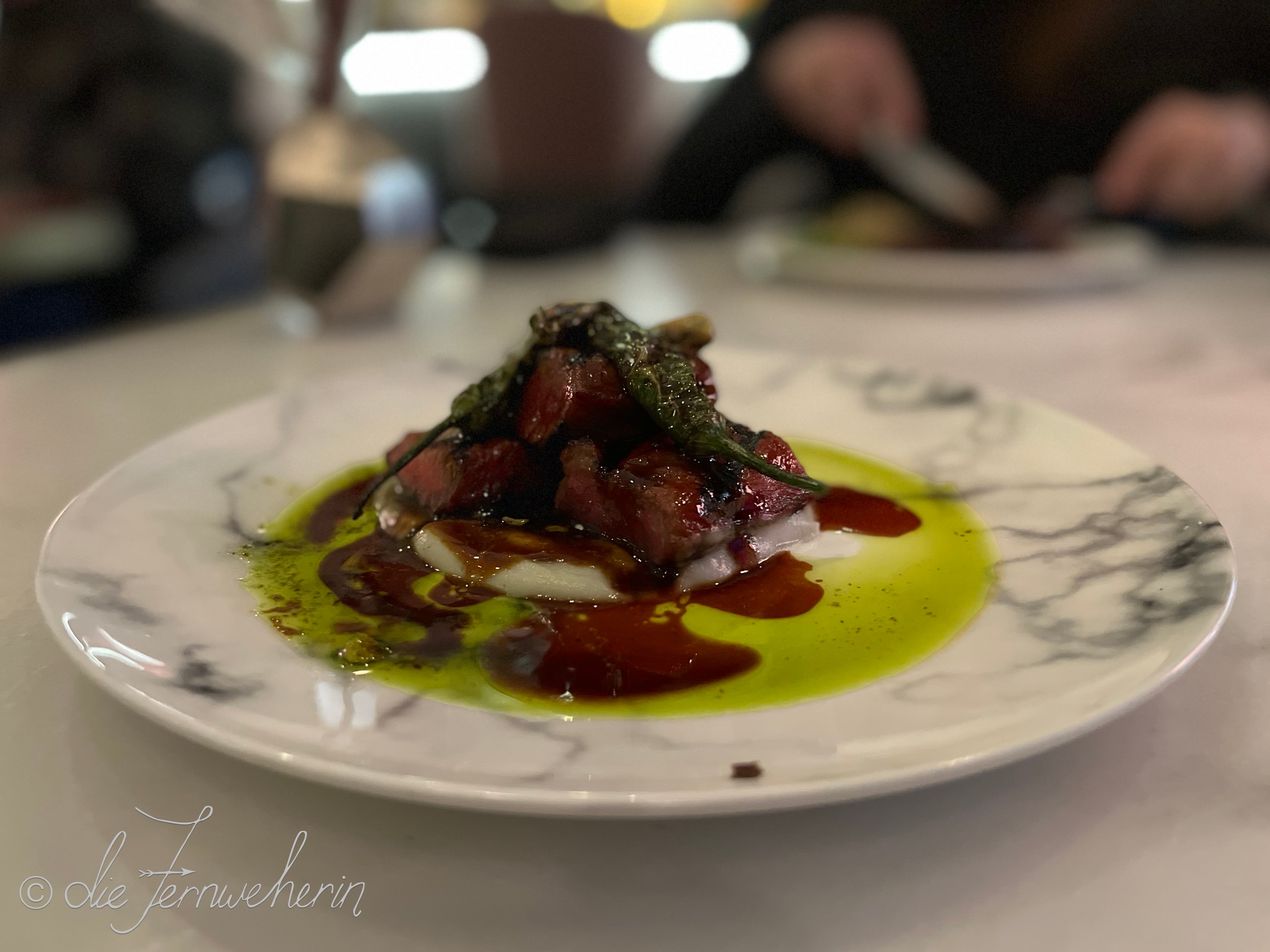 The BBQ Lamb Saddle, atop a pistachio pesto & sunchoke purée, and topped with blistered shishito peppers, at the Fairview Bar & Restaurant.