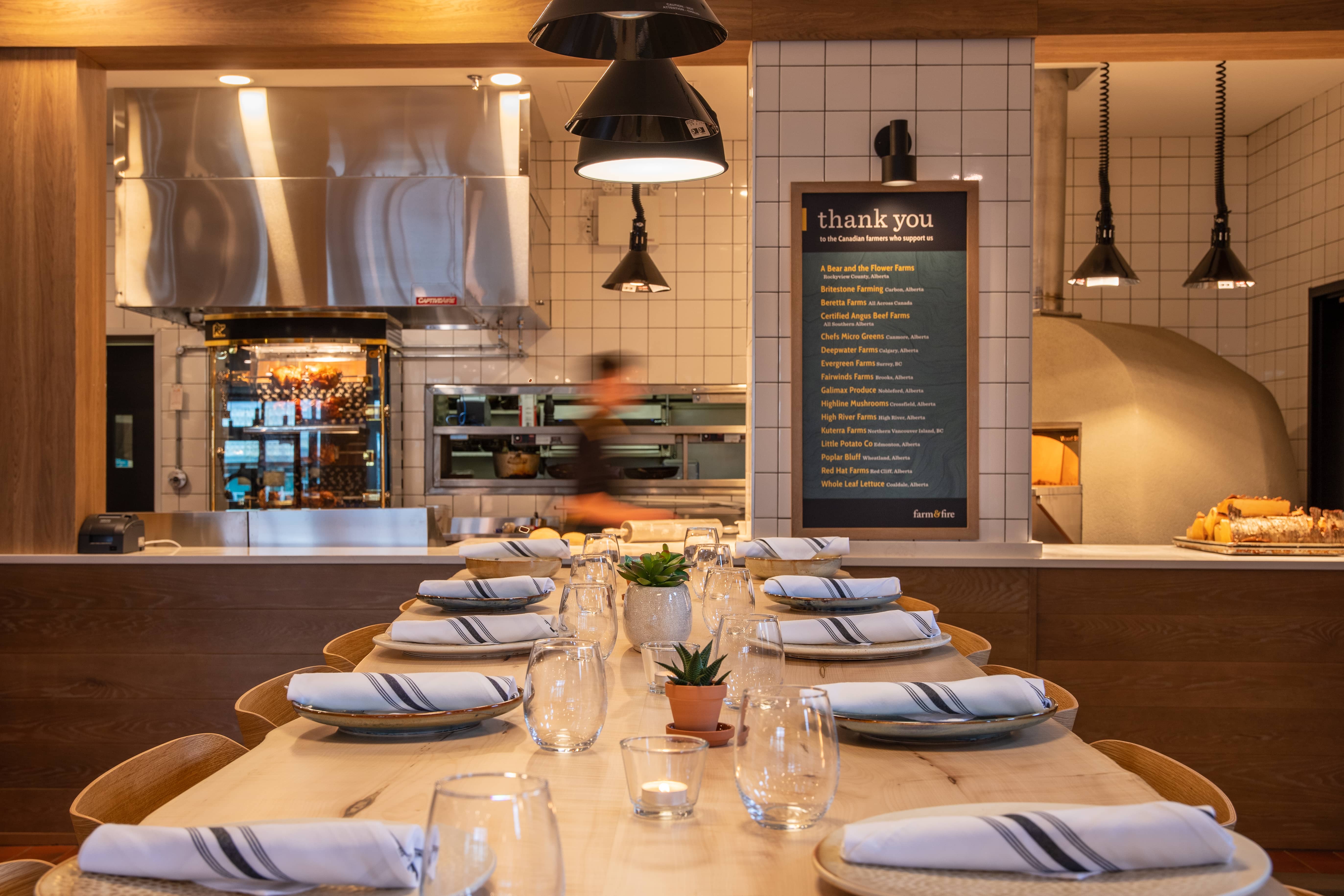 The open-concept kitchen at Farm & Fire, and a table set for a large group.