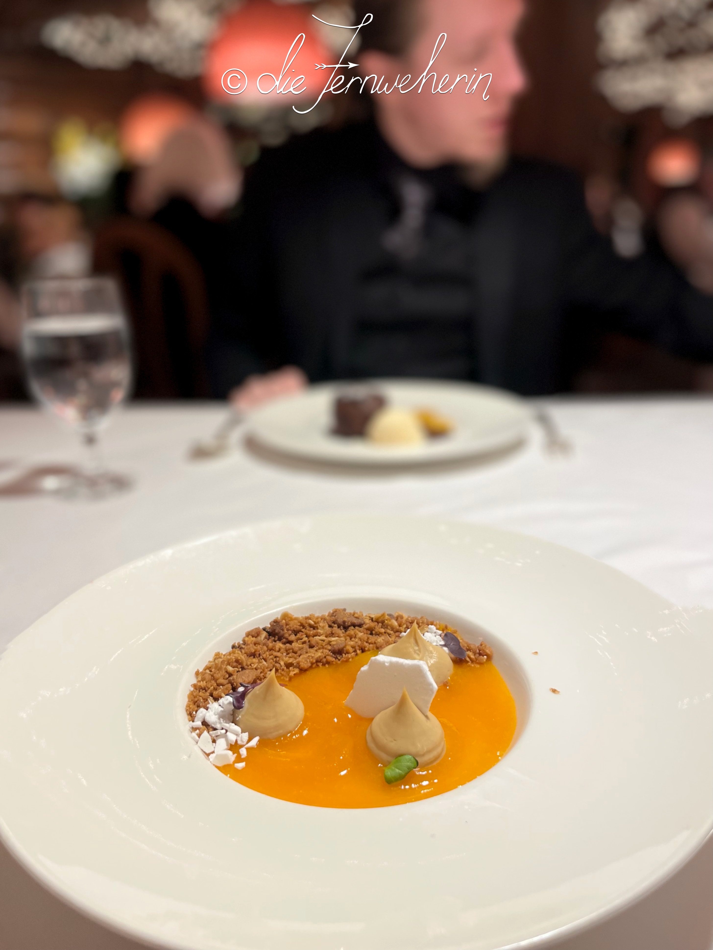 The Buttermilk Pudding at the Post Hotel Dining Room, topped with house-made apricot gel, oatmeal crumble, dehydrated marshmallow, and peach tea crémeux.