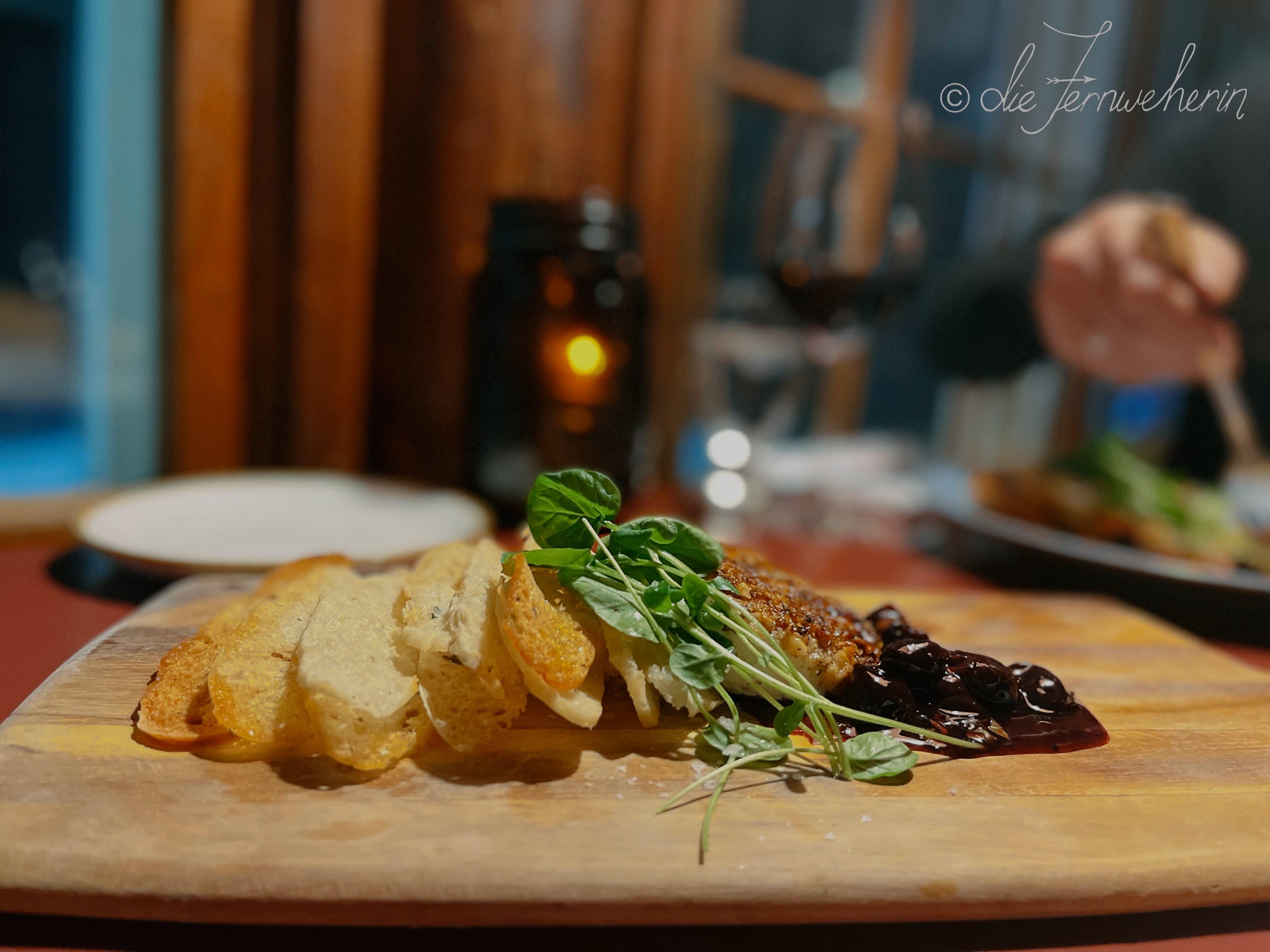 The heavenly Baked Goat Cheese appetizer at Storm Mountain Lodge: warm, walnut-crusted chèvre served with housemade crostini and sour cherry jam.