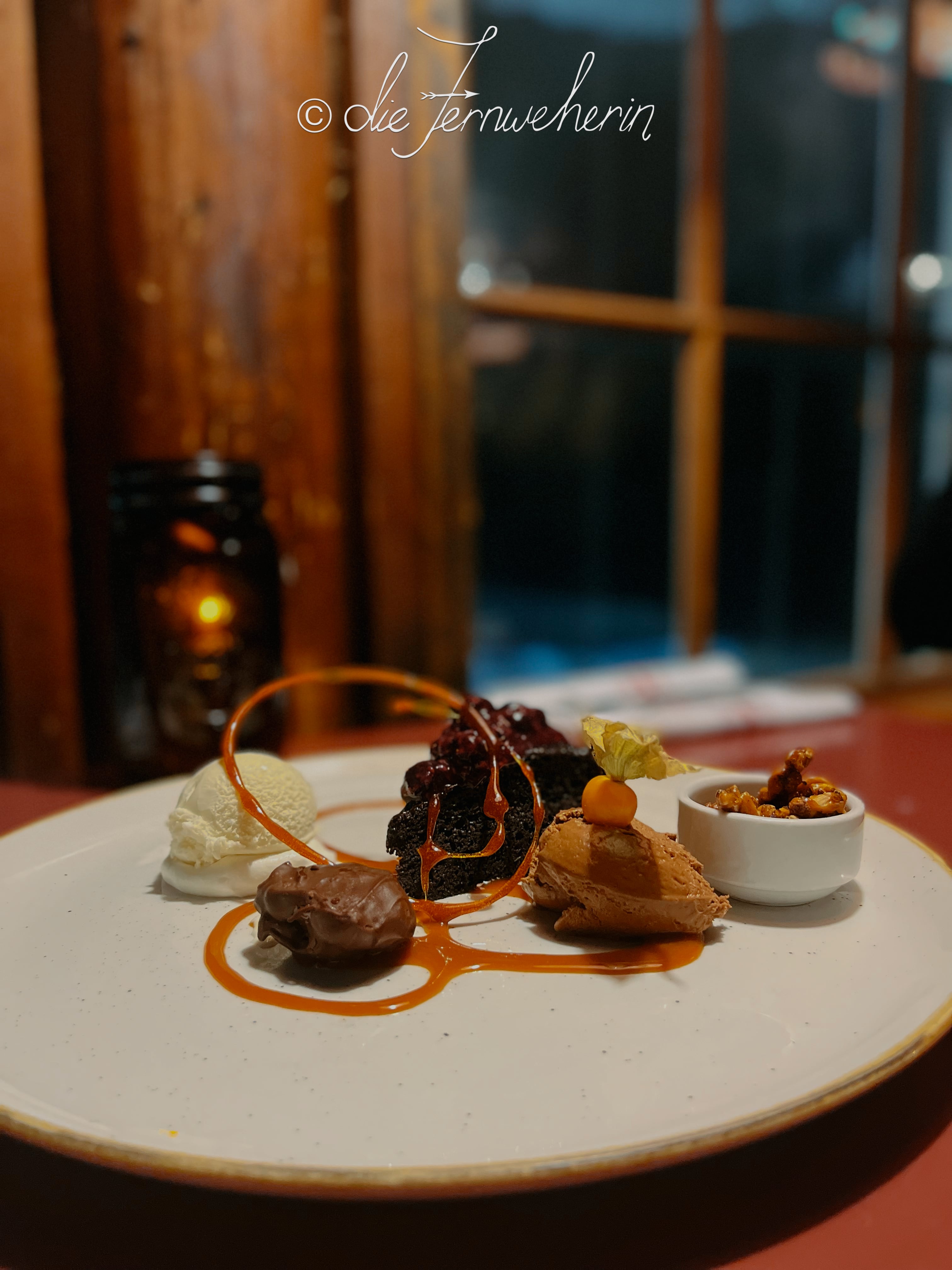 The mouthwatering Chocolate Trio dessert at Storm Mountain Lodge, consisting of chocolate mousse, chocolate cake, and a housemade chocolate truffle.