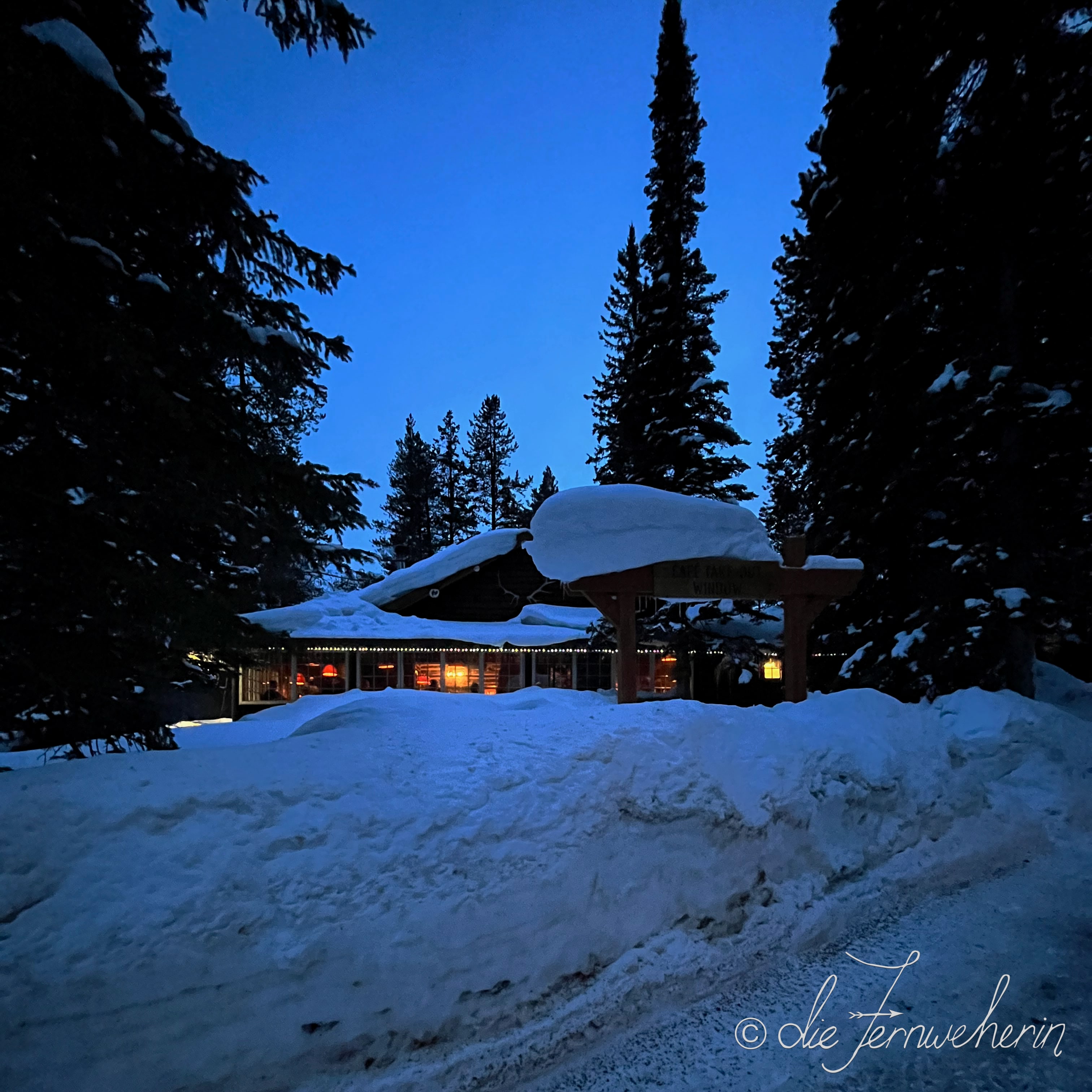 Dusk falls on snow-covered Storm Mountain Lodge, a restaurant in Banff National Park.