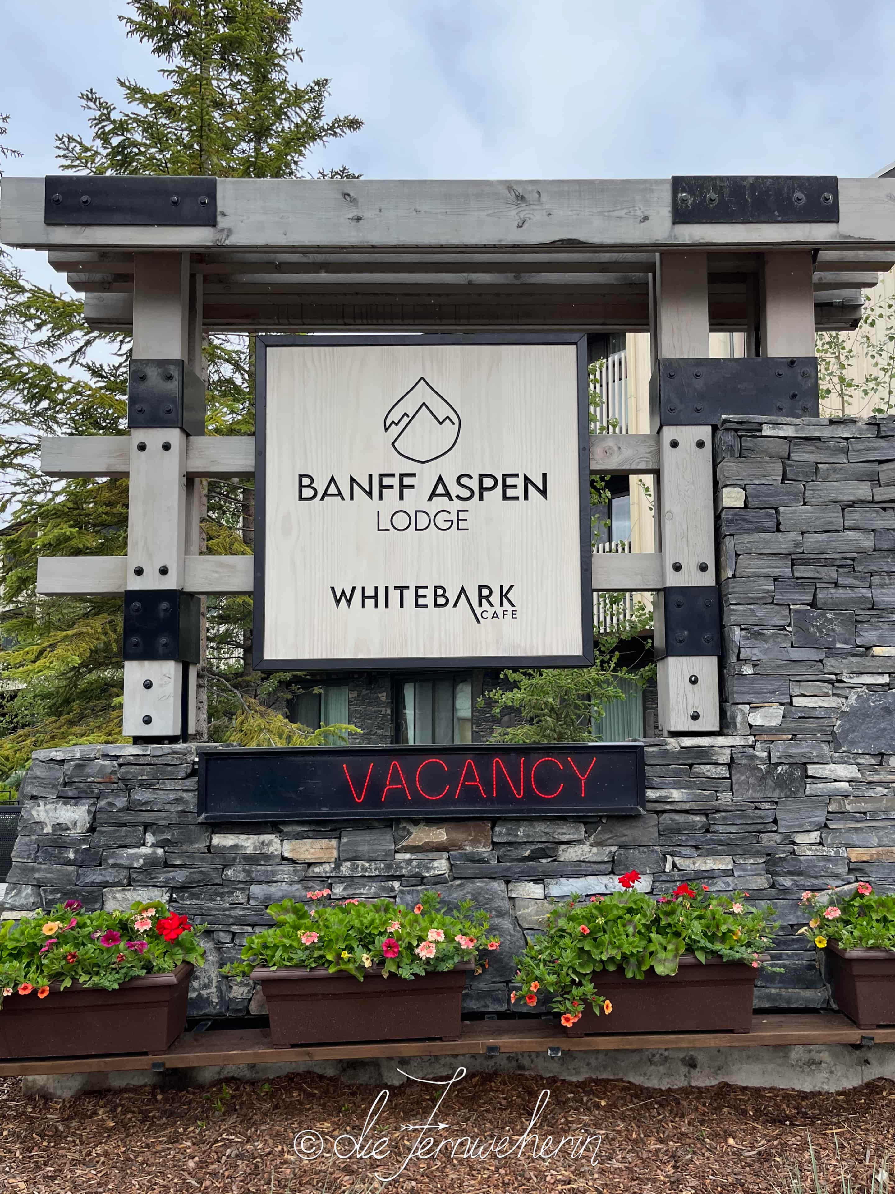 The sign for the Whitebark Café & Banff Aspen Lodge in the town of Banff.
